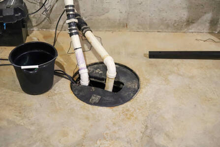 Sump pump installed in a basement floor.